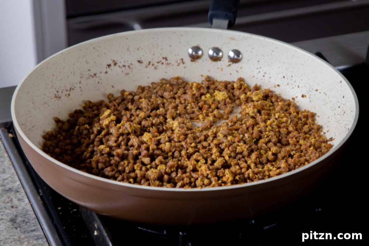 Popped Lentils and Whipped Potatoes 14 Crispy, spiced popped lentils in the frying pan, ready to be served, showcasing their golden-brown and flavorful appearance.