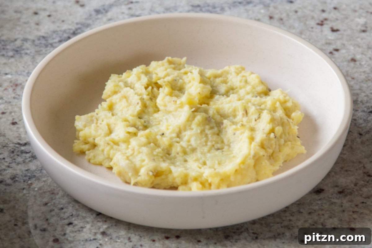 Popped Lentils and Whipped Potatoes 15 A serving bowl filled with the creamy potato-cauliflower mash, prepared and ready for topping.