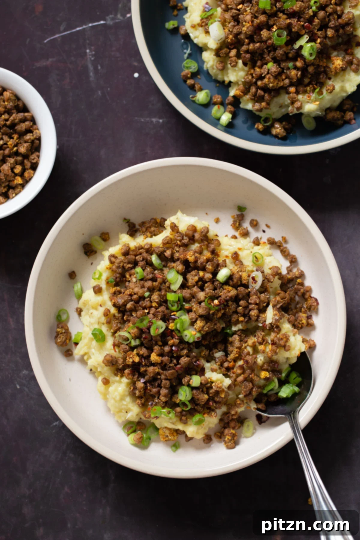 Popped Lentils and Whipped Potatoes 3 Two bowls of Popped Lentil Mashed Potatoes, beautifully garnished, inviting a taste of this wholesome vegan dish.