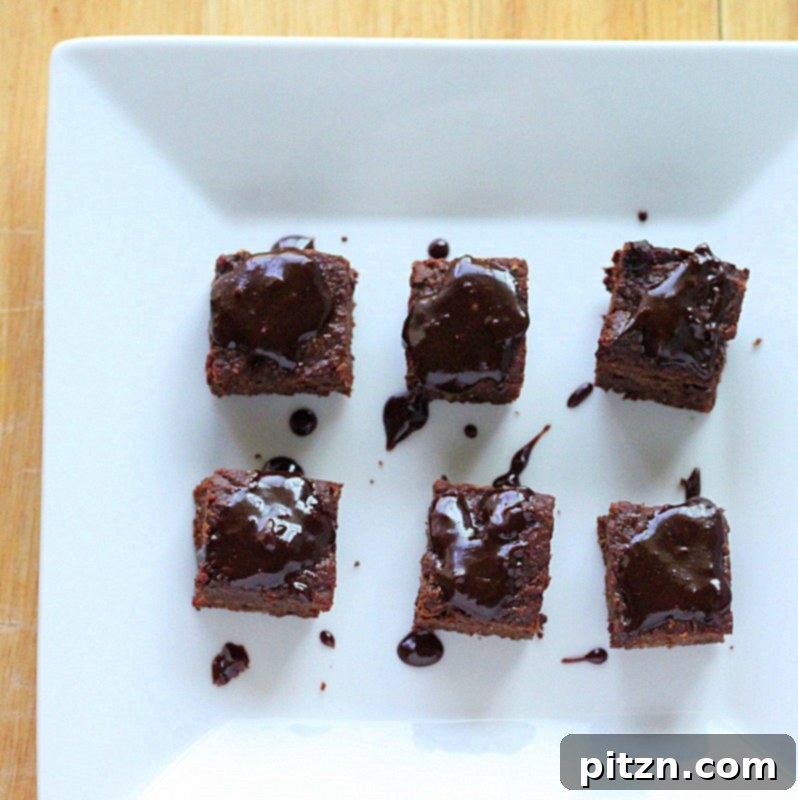 A plate of freshly baked and sliced vegan chocolate brownies, ready to be enjoyed