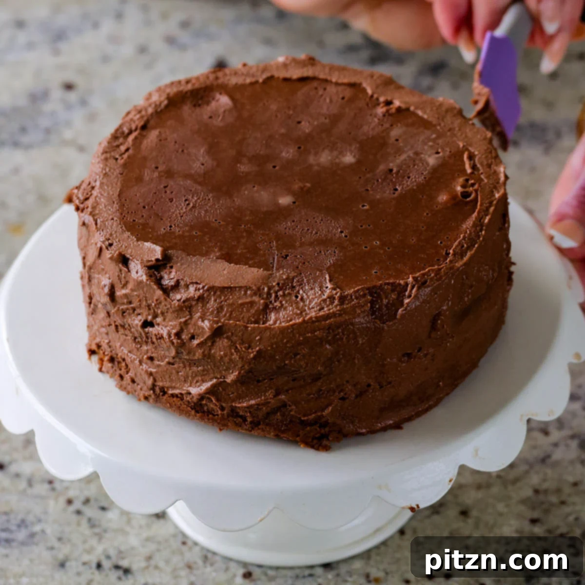 Decadent Vegan Mocha Cake with Velvety Chocolate Mousse (Gluten-Free Option) 23 spreading frosting onto the mocha cake