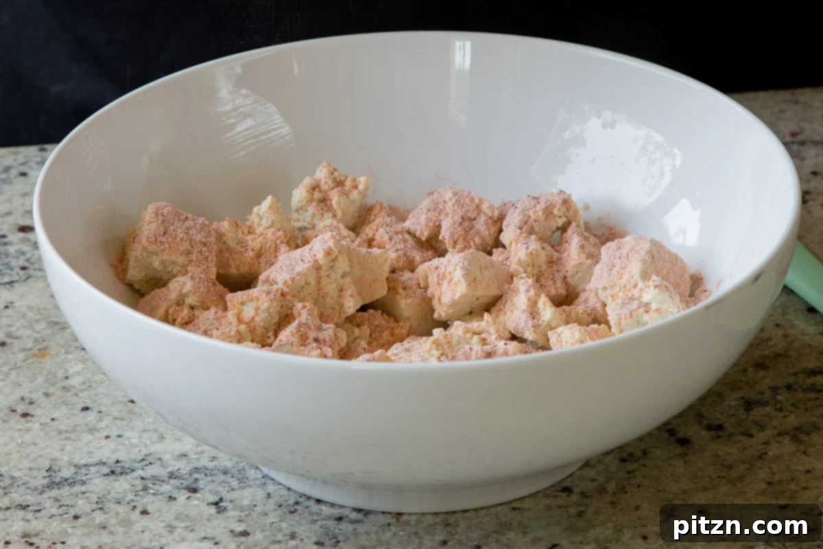 South Indian Black Pepper Tofu Fry 8 Seasoning torn tofu with spices and cornstarch in a bowl