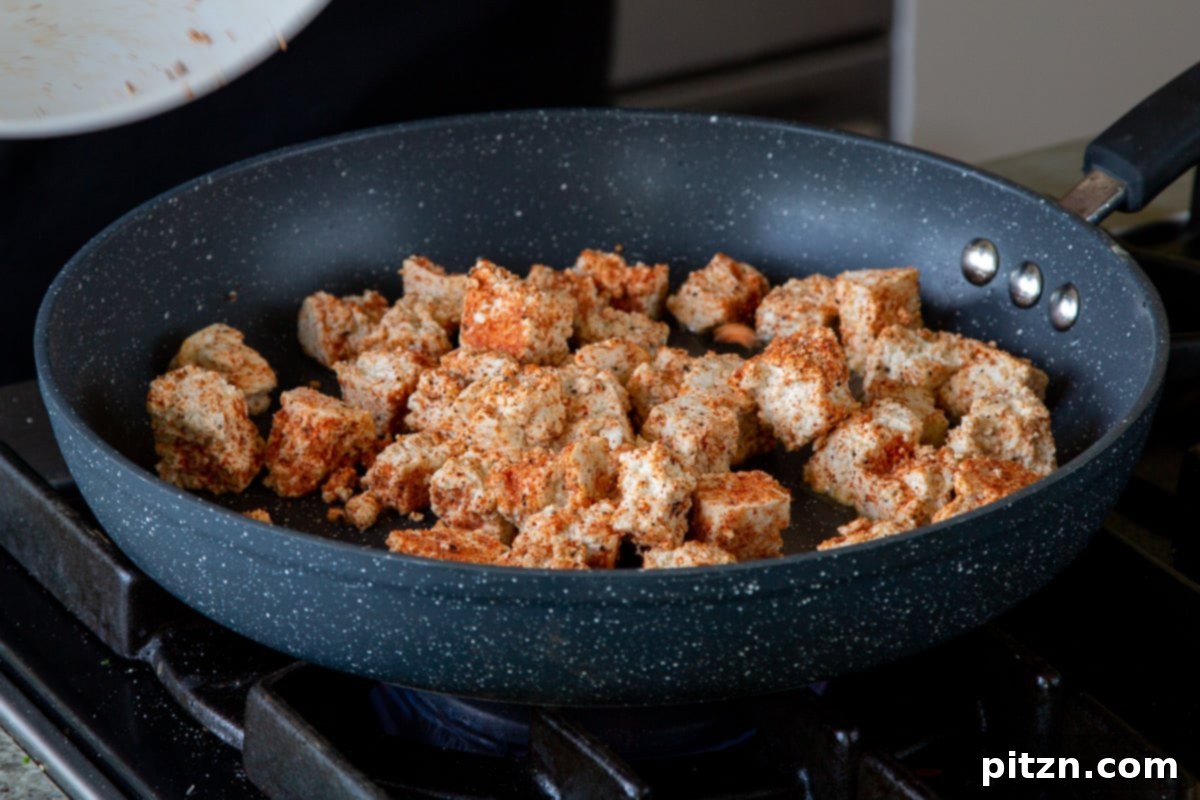 South Indian Black Pepper Tofu Fry 11 Seasoned tofu spread out in a hot pan, beginning to crisp