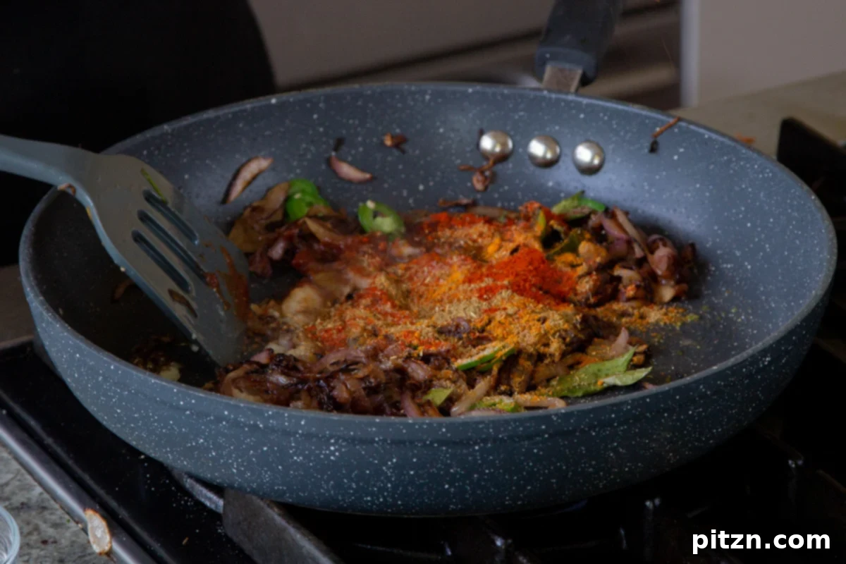 South Indian Black Pepper Tofu Fry 16 Adding ground spices to the caramelized onion mixture in the pan