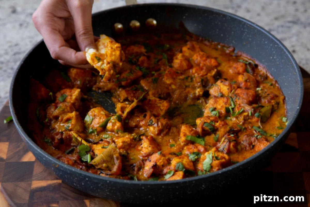 South Indian Black Pepper Tofu Fry 20 Flatbread being dipped into a skillet of hot Tofu Pepper Fry