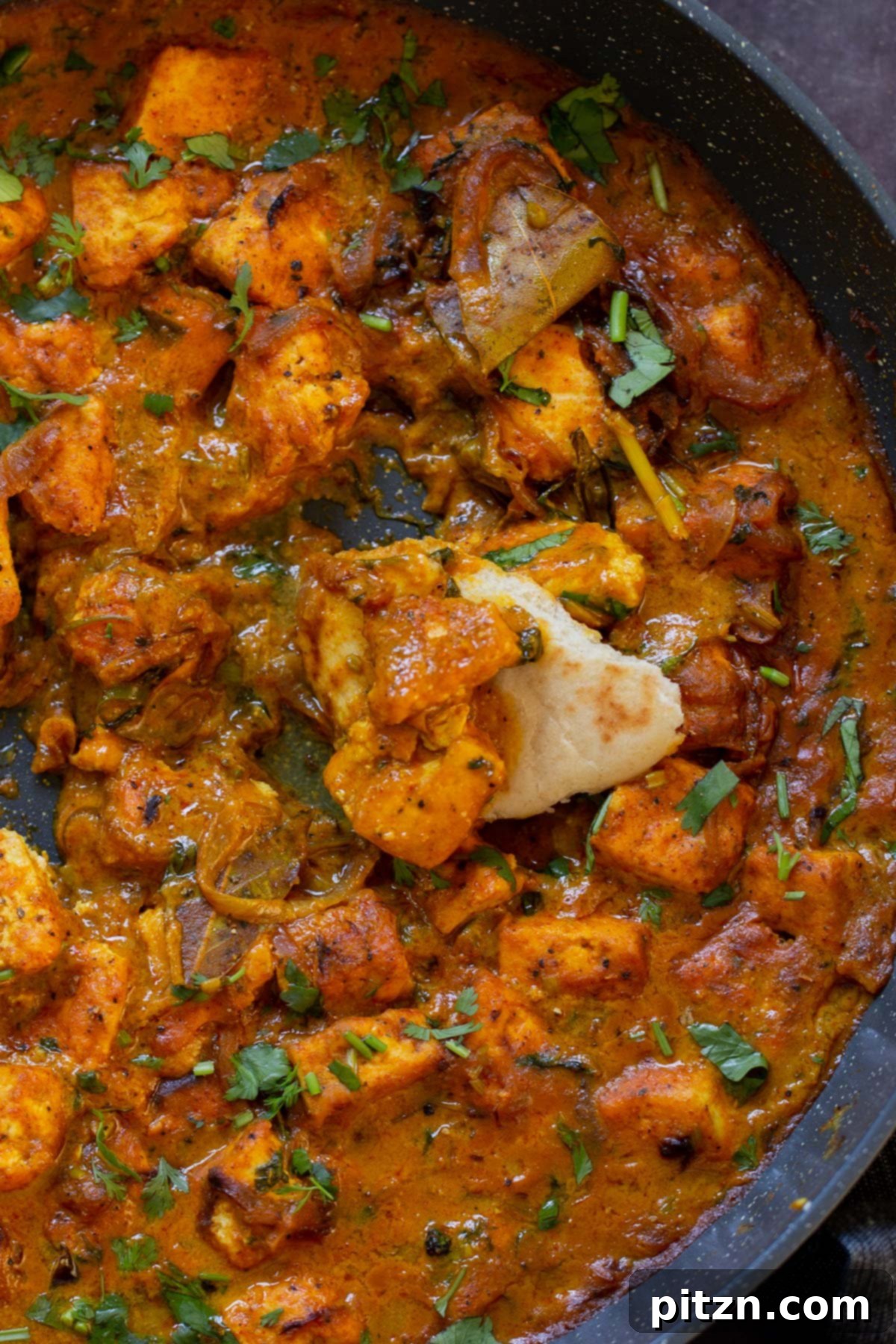 South Indian Black Pepper Tofu Fry 21 Close-up of dipping flatbread into tofu pepper fry in the skillet