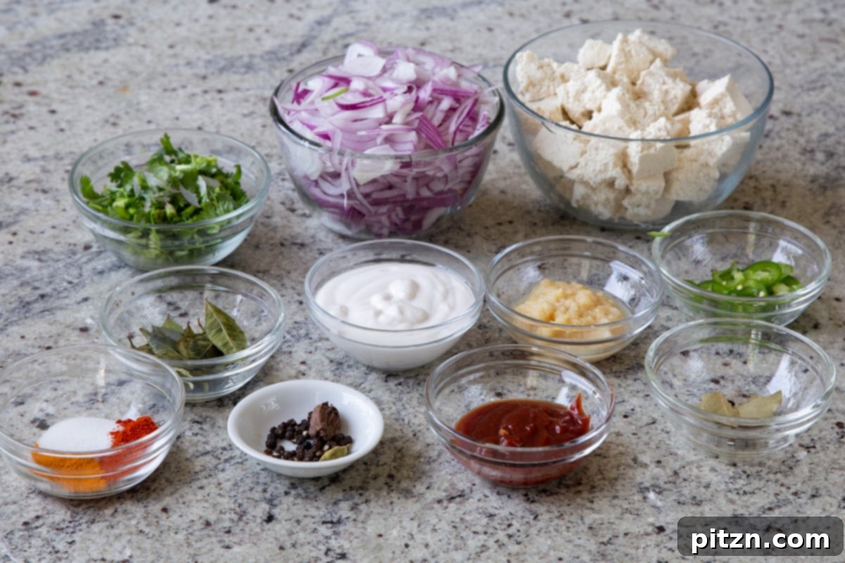 South Indian Black Pepper Tofu Fry 5 Bowls of prepped ingredients for Tofu Pepper Fry on a kitchen counter: tofu, spices, onions, cilantro, chili