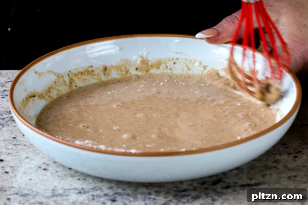 The Inclusive Crispy Vegan Chicken Sandwich 12 batter ingredients in a bowl after mixing