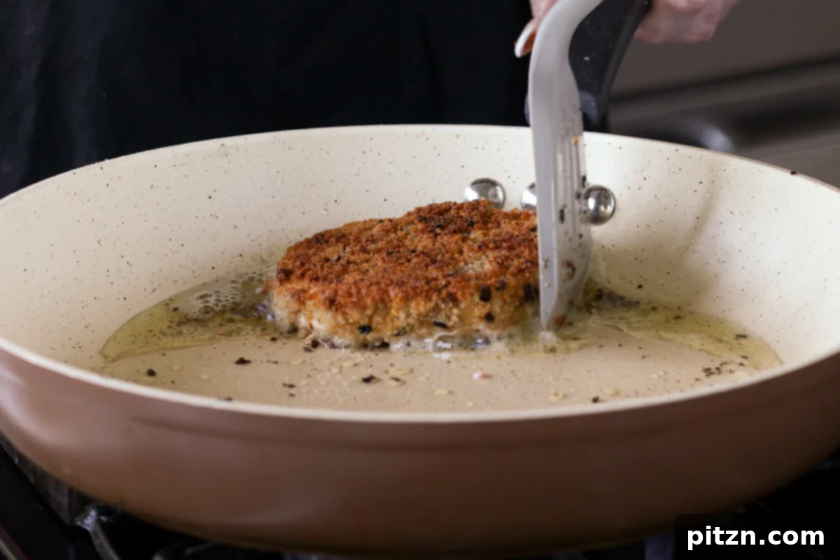 The Inclusive Crispy Vegan Chicken Sandwich 18 crispy vegan chicken cutlet in the frying pan