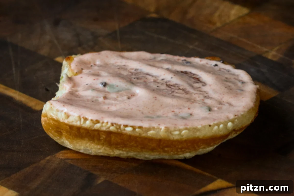 The Inclusive Crispy Vegan Chicken Sandwich 21 spicy mayo spread onto a toasted bun
