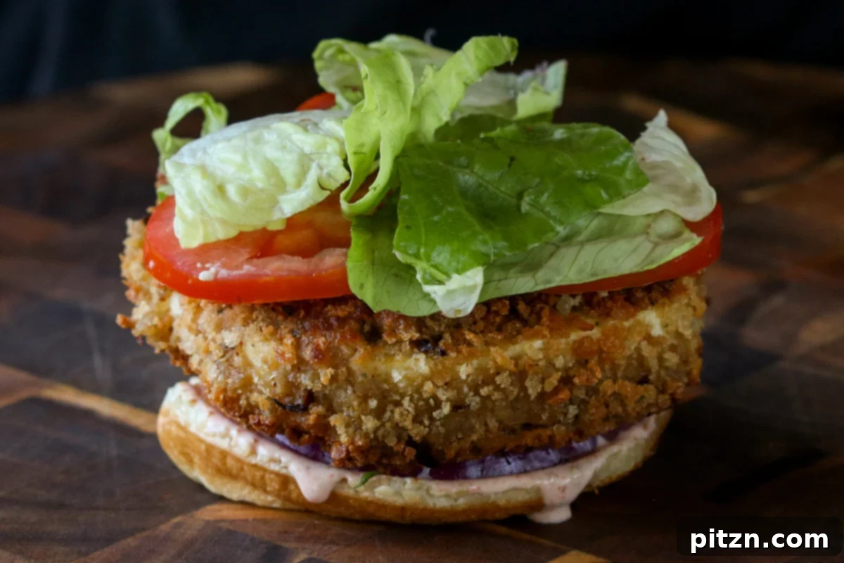 The Inclusive Crispy Vegan Chicken Sandwich 22 crispy vegan chicken patty, lettuce, onion, and tomatoes on the bun