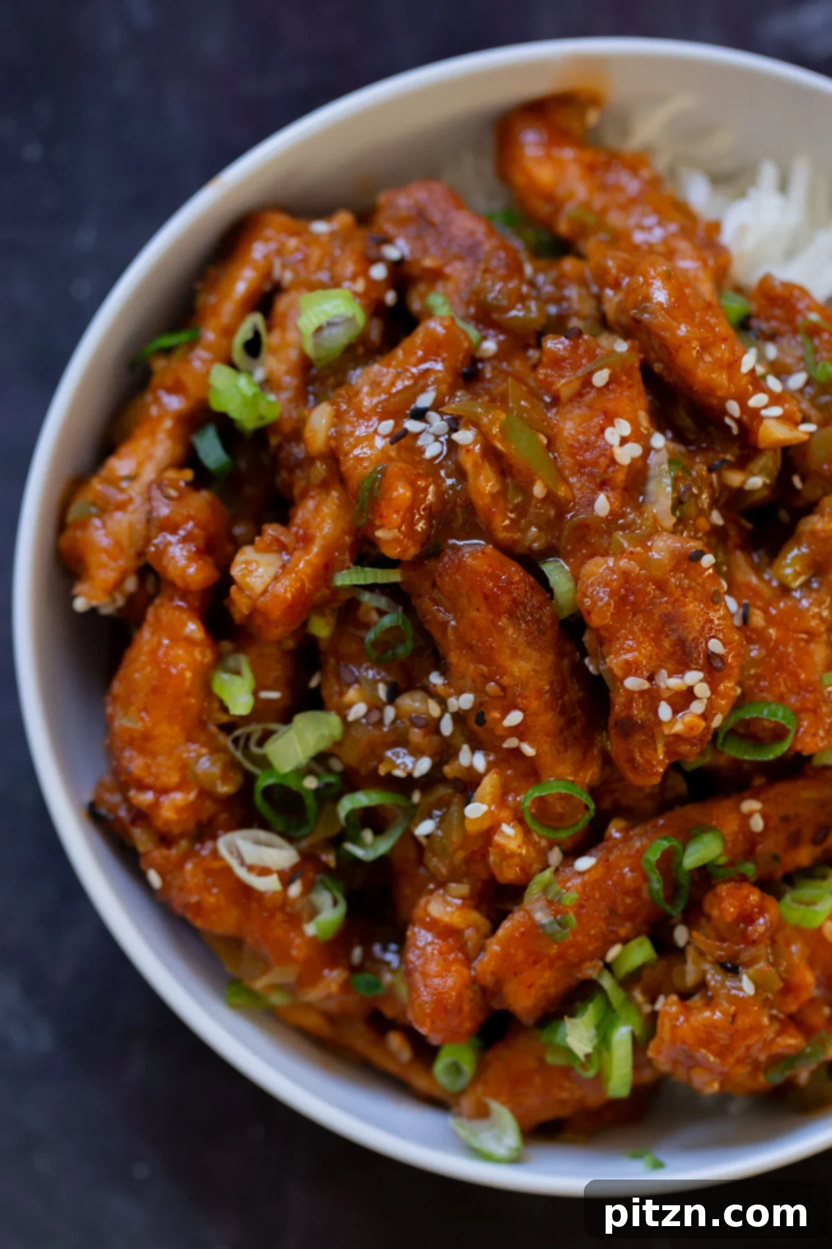 Zesty Indo Chinese Crispy Chicken and Soy Curls Nut Free Gluten Free Soy Free Adaptable 3 overhead close-up of crispy Indo Chinese chicken in a bowl with rice and green onions