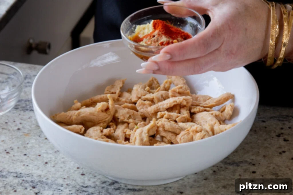 Zesty Indo Chinese Crispy Chicken and Soy Curls Nut Free Gluten Free Soy Free Adaptable 9 adding spices to the bowl of soy curls