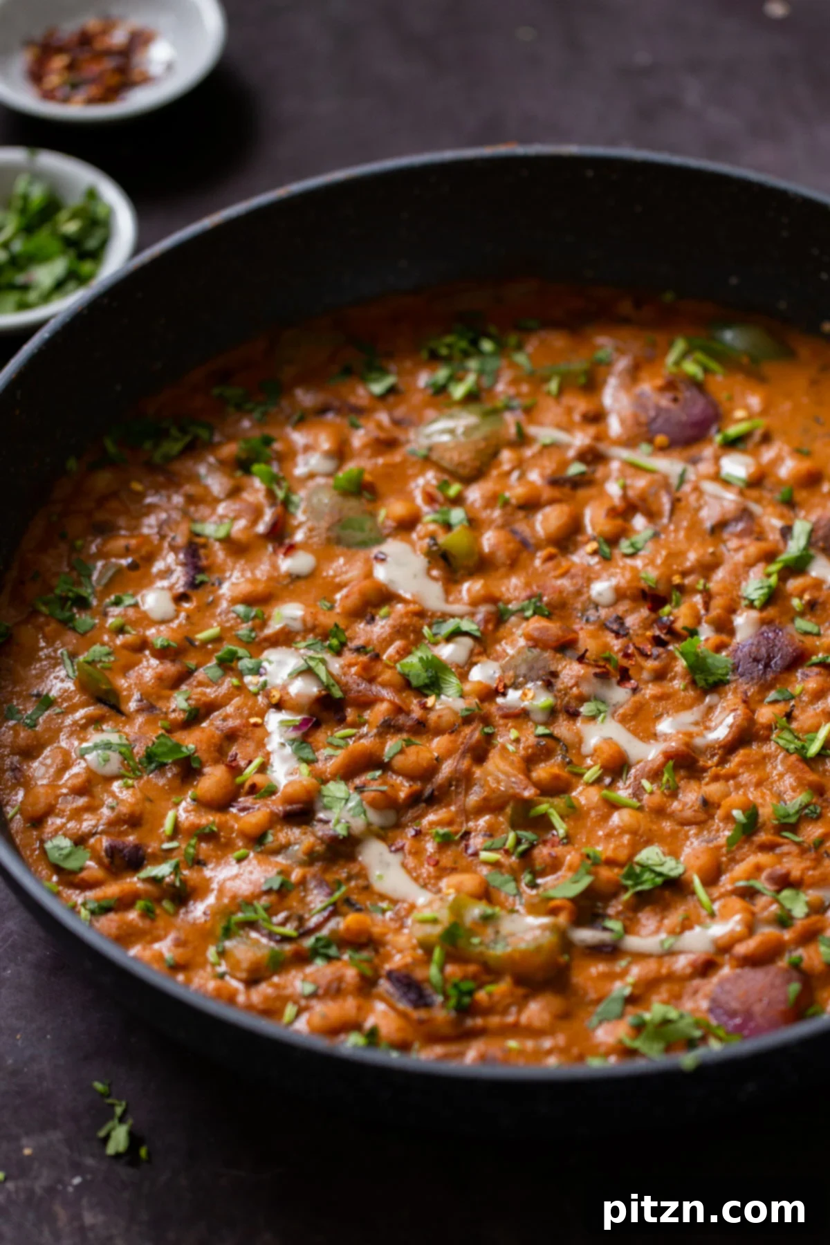 One Pot White Bean Do Pyaza Curry 2 Beans Do Pyaza in a pan after cooking, showcasing the rich, creamy texture and vibrant garnish