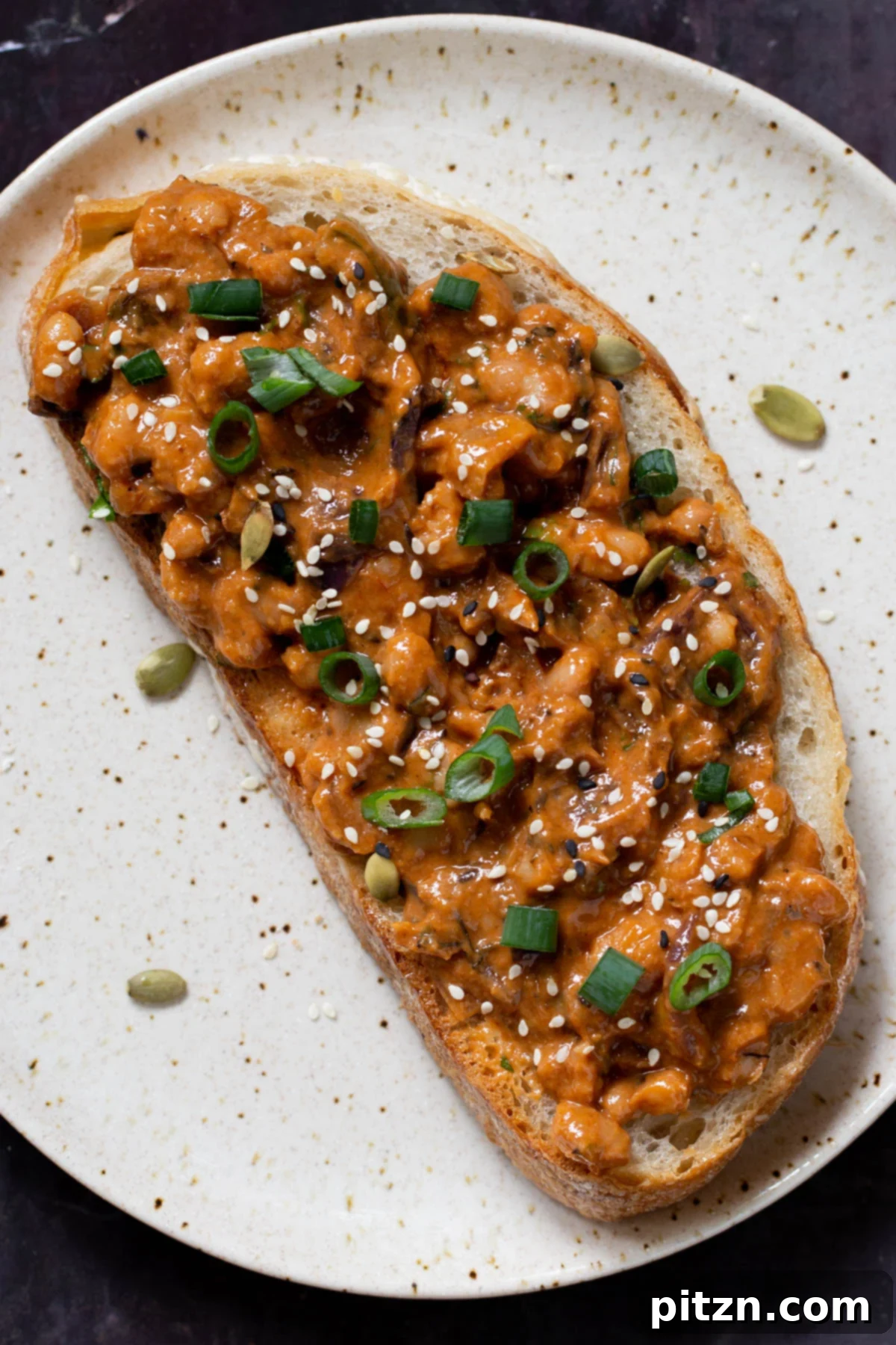 One Pot White Bean Do Pyaza Curry 4 Beans Do Pyaza served as a gourmet beans on toast, garnished with fresh herbs and seeds