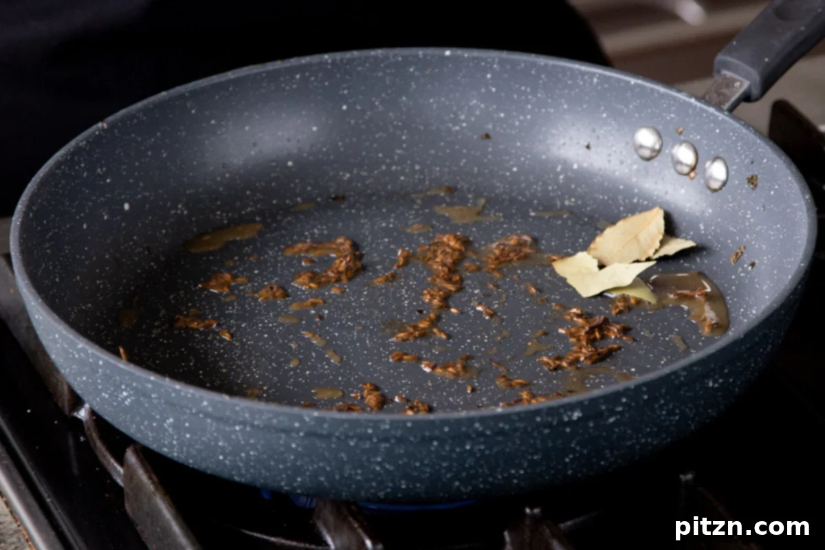 One Pot White Bean Do Pyaza Curry 8 Whole cumin seeds toasting in hot oil in a skillet, turning fragrant and slightly darker.