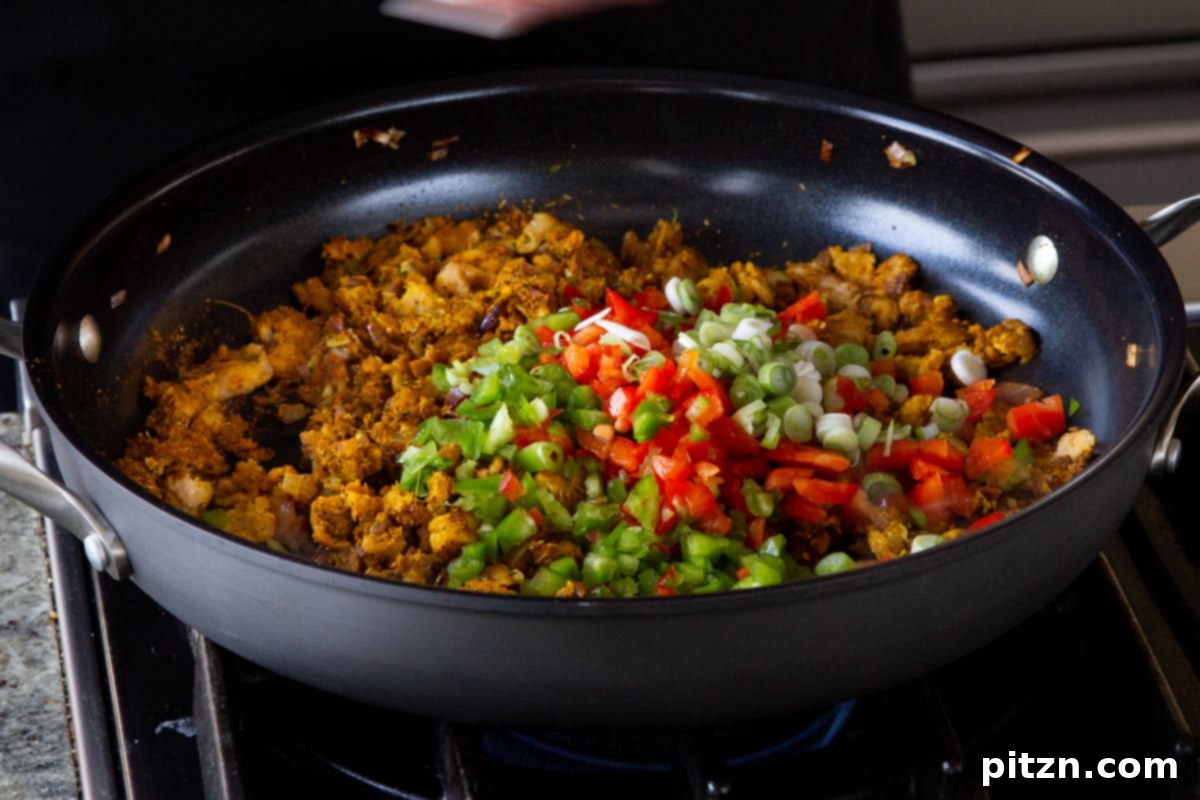 Simple One Pot Jamaican Curry Rice Gluten Free Nut Free 10 Adding colorful chopped bell pepper and fresh green onion to the pan, mixing with the seasoned soy curls and spices.
