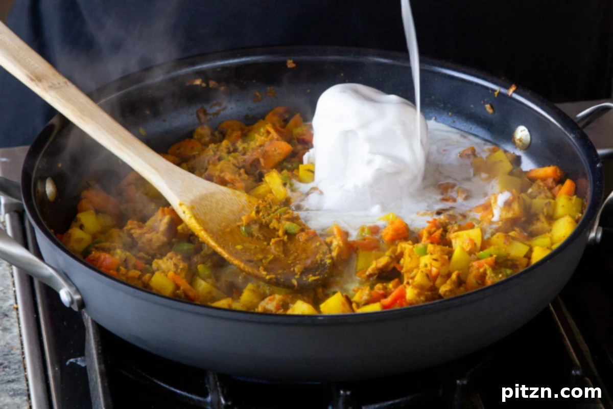 Simple One Pot Jamaican Curry Rice Gluten Free Nut Free 14 Adding creamy coconut milk and the reserved broth to the seasoned vegetables in the pan, stirring to create the luscious curry sauce.