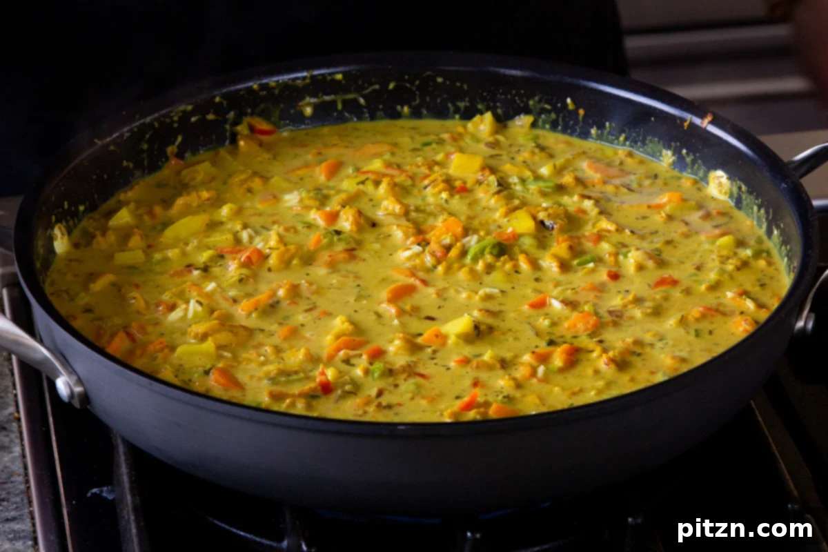 Simple One Pot Jamaican Curry Rice Gluten Free Nut Free 17 White rice gently stirred into the rich Jamaican curry sauce, now ready for simmering under a lid.