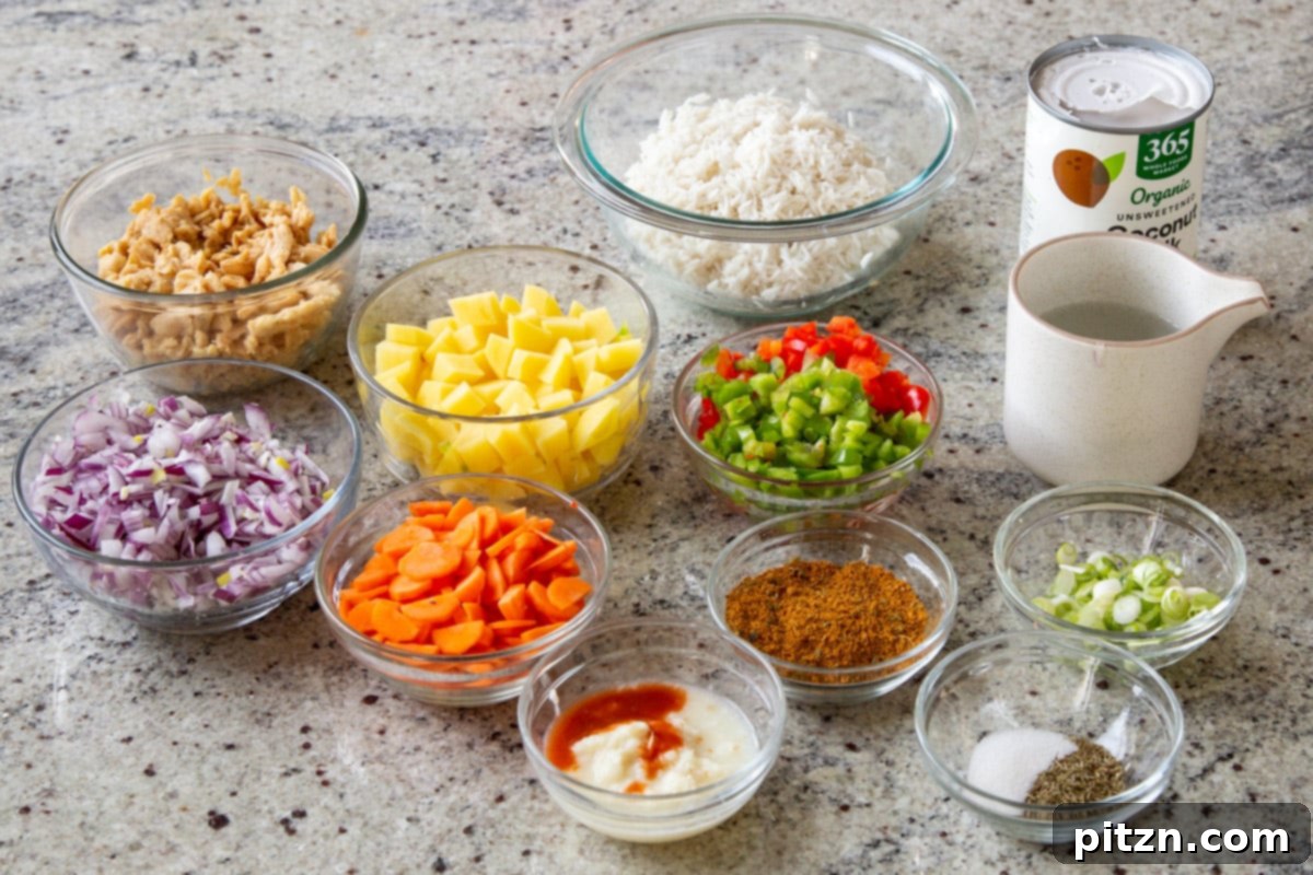 Simple One Pot Jamaican Curry Rice Gluten Free Nut Free 6 Assortment of fresh ingredients for Jamaican Curry Rice laid out on a kitchen counter, including white rice, cubed potatoes, various spices, and coconut milk in bowls.