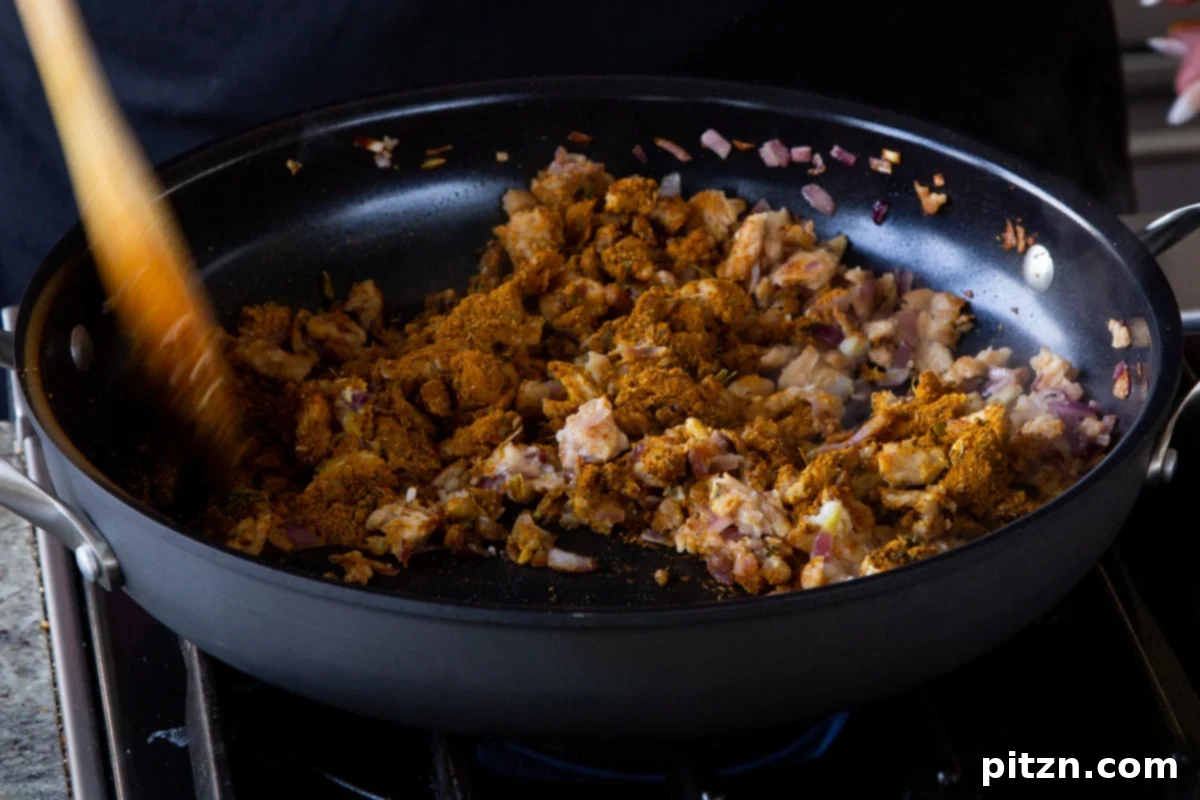 Simple One Pot Jamaican Curry Rice Gluten Free Nut Free 9 Sprinkling vibrant Jamaican curry powder and dried thyme into the pan with soy curls and aromatics, preparing to infuse the flavors.