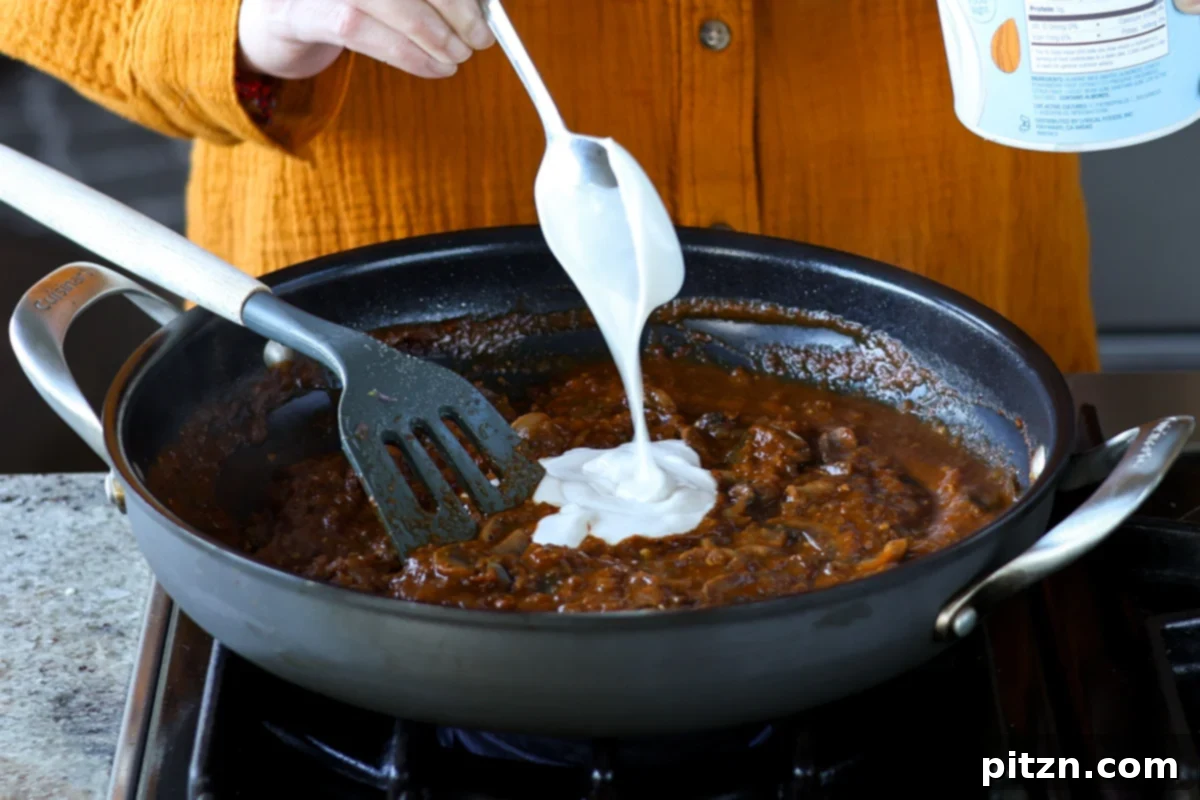 adding non-dairy yogurt to the balchao mushrooms