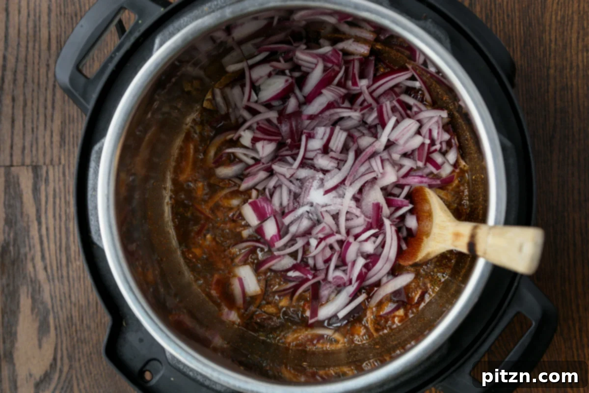 Instant Pot and Stovetop Punjabi Chole North Indian Chickpea Curry 10 adding onions to the pot