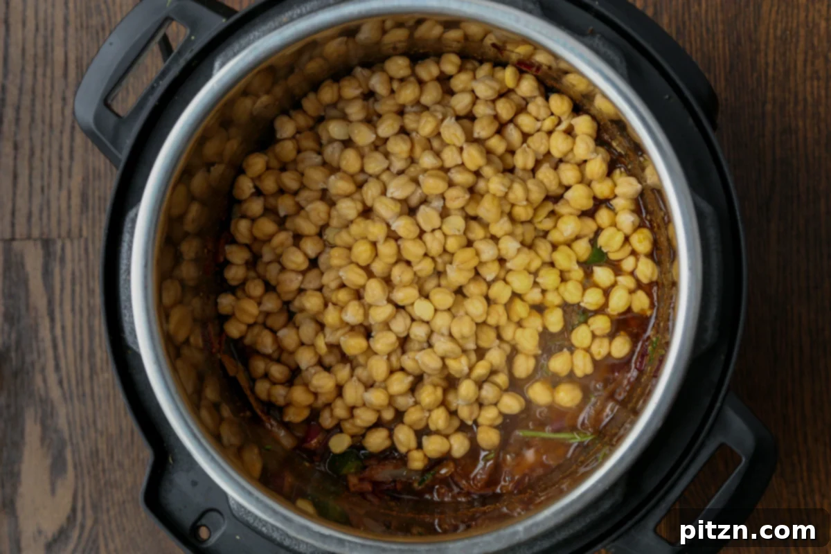 Instant Pot and Stovetop Punjabi Chole North Indian Chickpea Curry 13 adding chickpeas to the pot