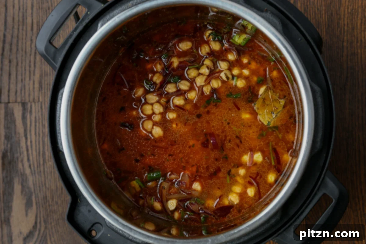 Instant Pot and Stovetop Punjabi Chole North Indian Chickpea Curry 14 adding dried spices and water to the chickpea mixture