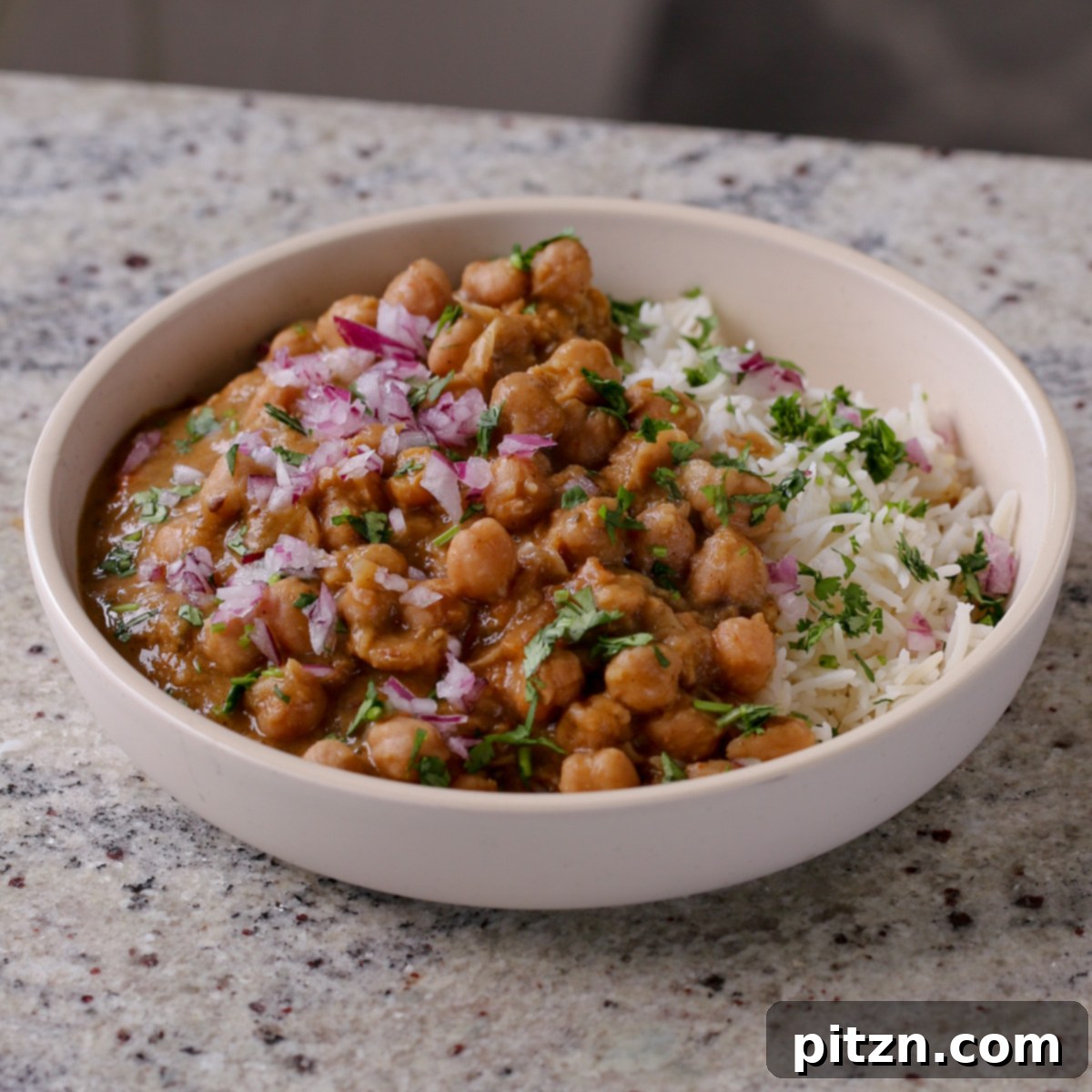 Instant Pot and Stovetop Punjabi Chole North Indian Chickpea Curry 22 Punjabi chole in a bowl with rice and cilantro