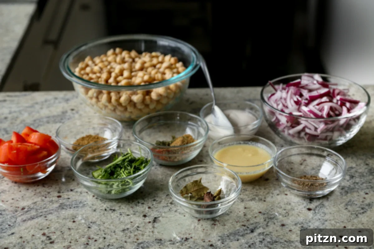 Instant Pot and Stovetop Punjabi Chole North Indian Chickpea Curry 6 chickpeas, spices, and other chole ingredients in bowls on the kitchen counter