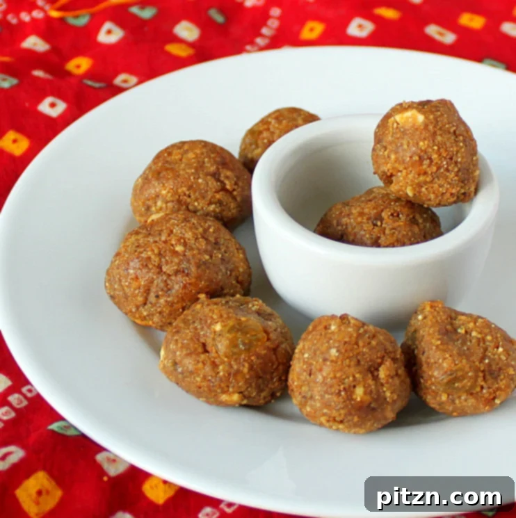 Golden Besan Laddoo with cashews and raisins, a traditional Indian sweet.
