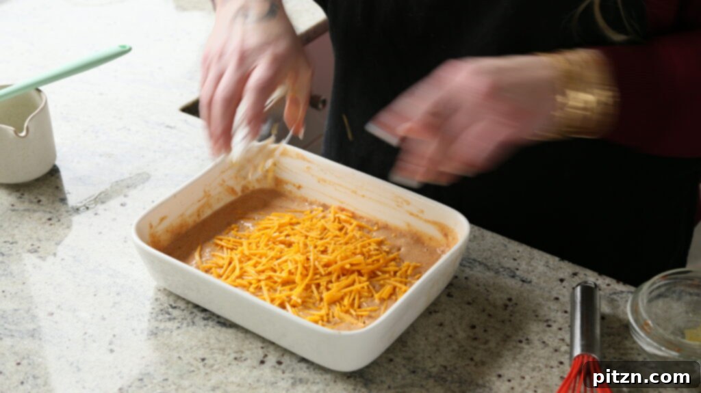 Creamy Smoky Vegan Mac and Cheese Bake 11 folding the cheese into the smoky mac and cheese sauce