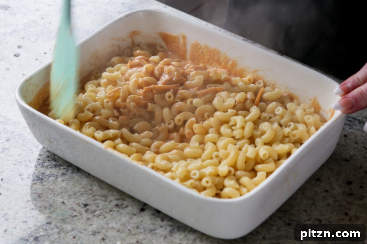 Creamy Smoky Vegan Mac and Cheese Bake 13 mixing the pasta into the sauce