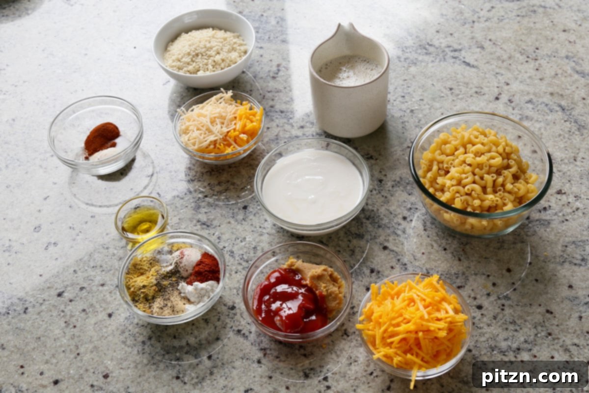 Creamy Smoky Vegan Mac and Cheese Bake 7 pasta, vegan cheese, and other mac and cheese ingredients in bowls on the kitchen counter