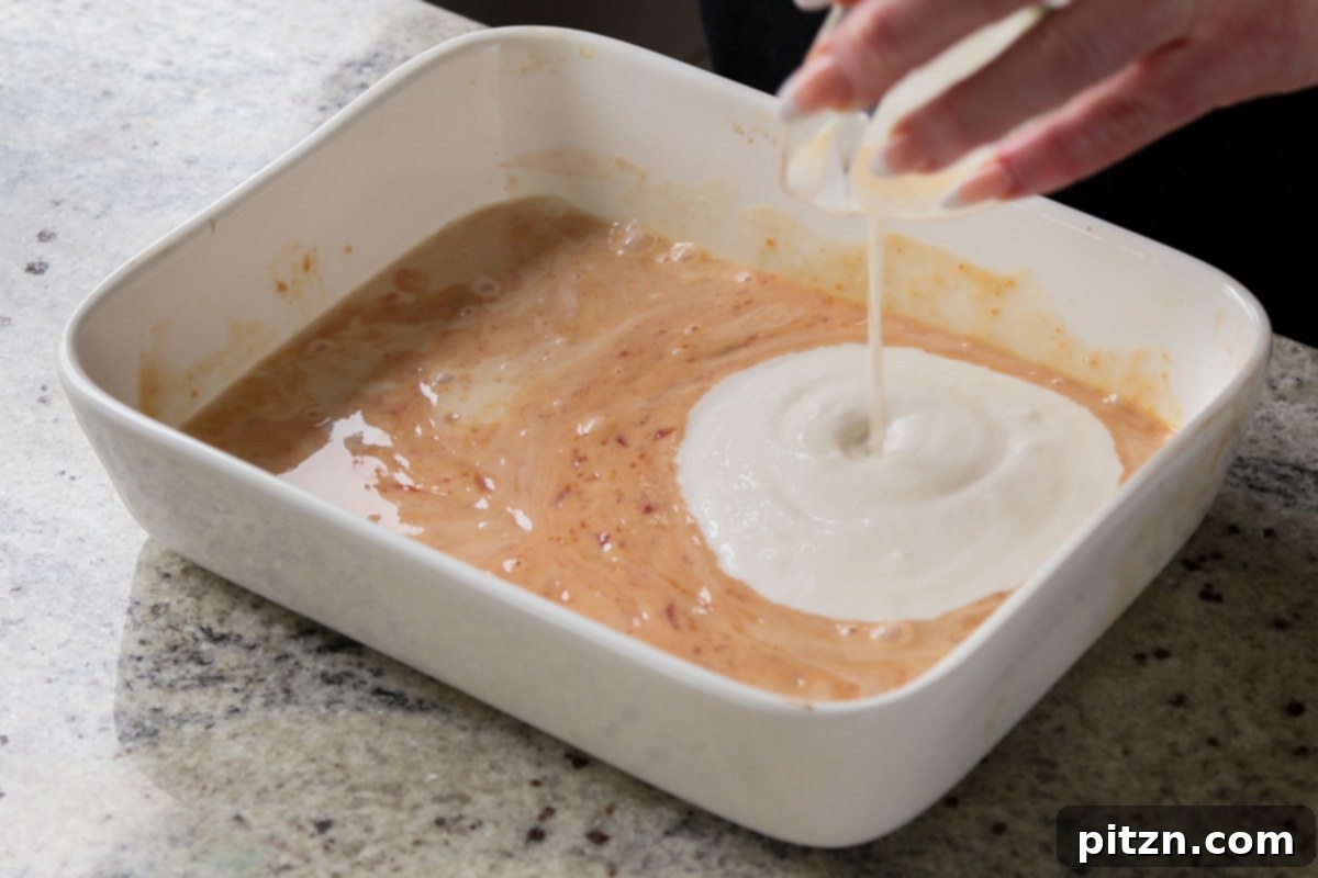 Creamy Smoky Vegan Mac and Cheese Bake 9 adding vegan sour cream to the sauce