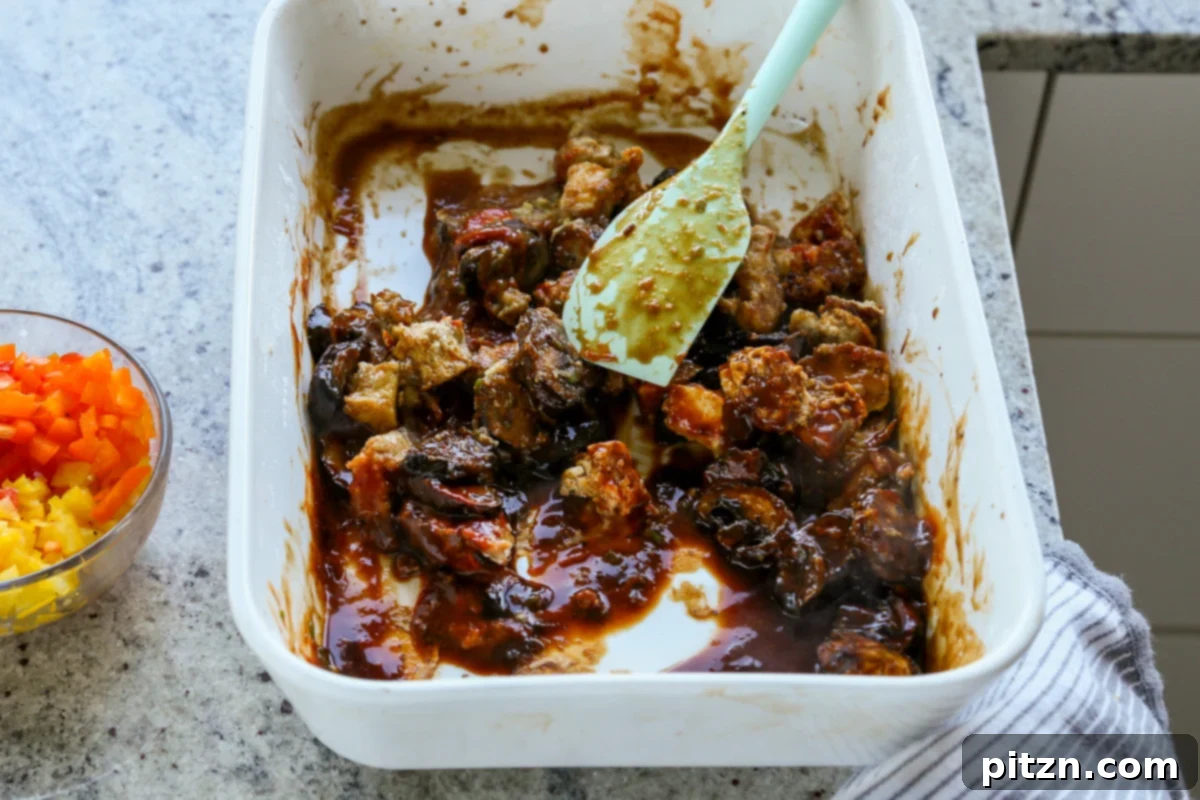 tossing tofu and mushrooms in the sauce