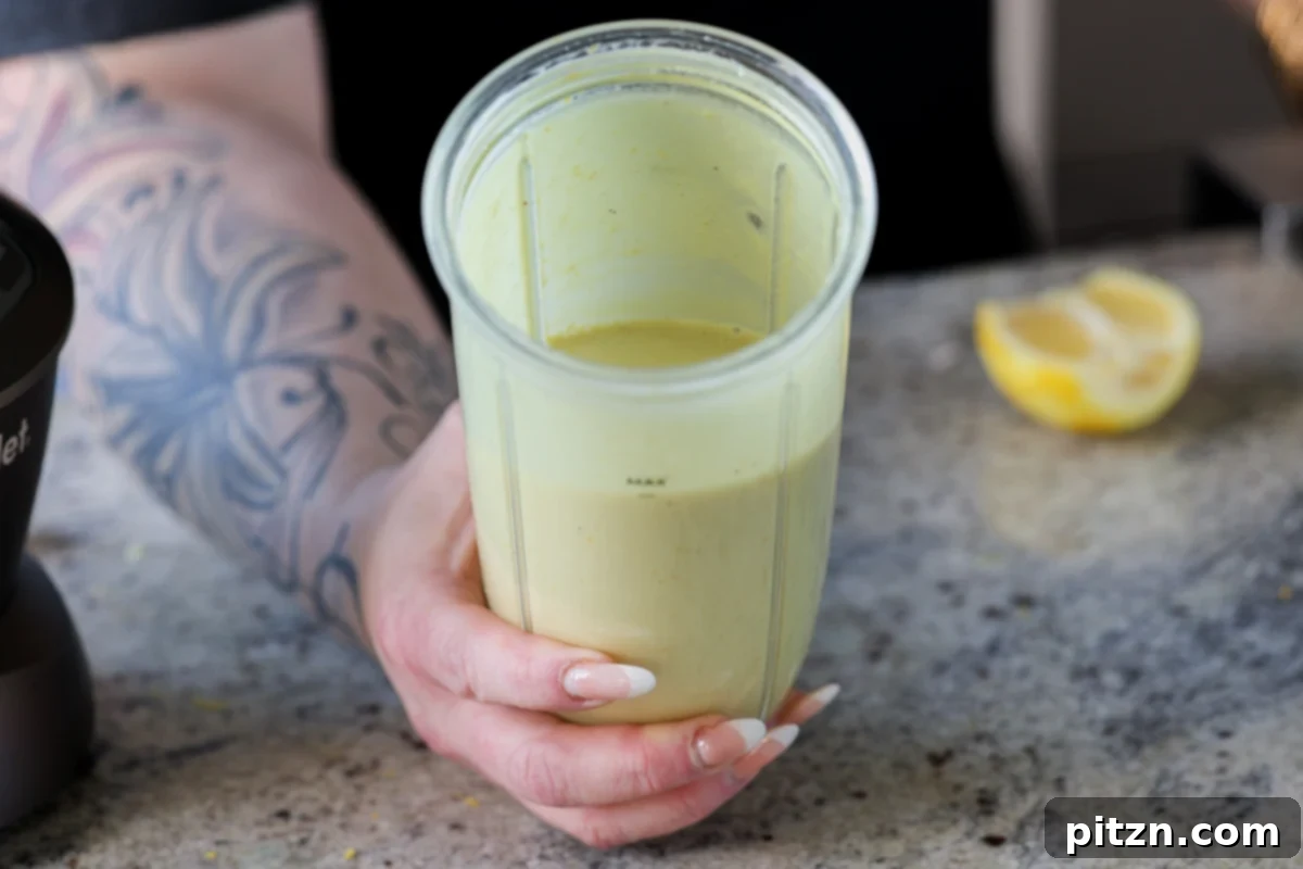 Zesty Vegan Lemon Cloud Cake 17 Smooth, creamy vegan lemon frosting in a blender after thorough blending