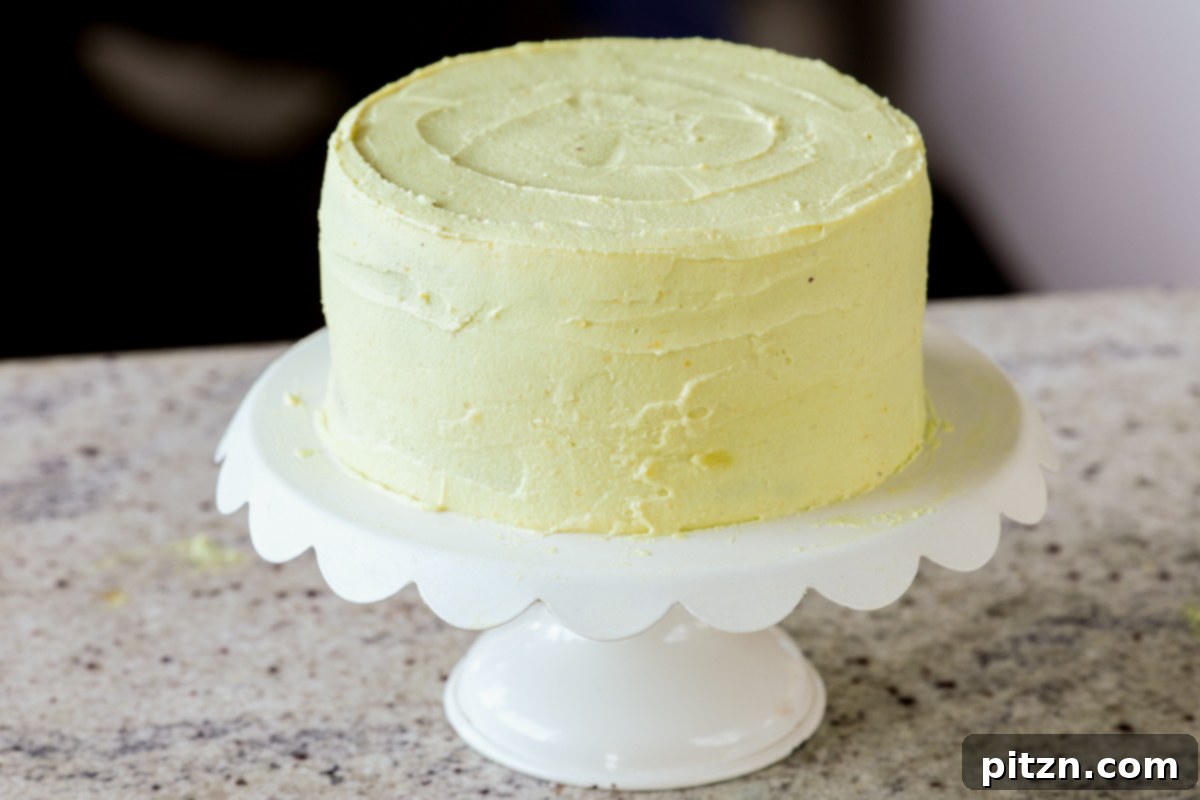 Zesty Vegan Lemon Cloud Cake 26 A fully frosted vegan lemon cake on a serving tray