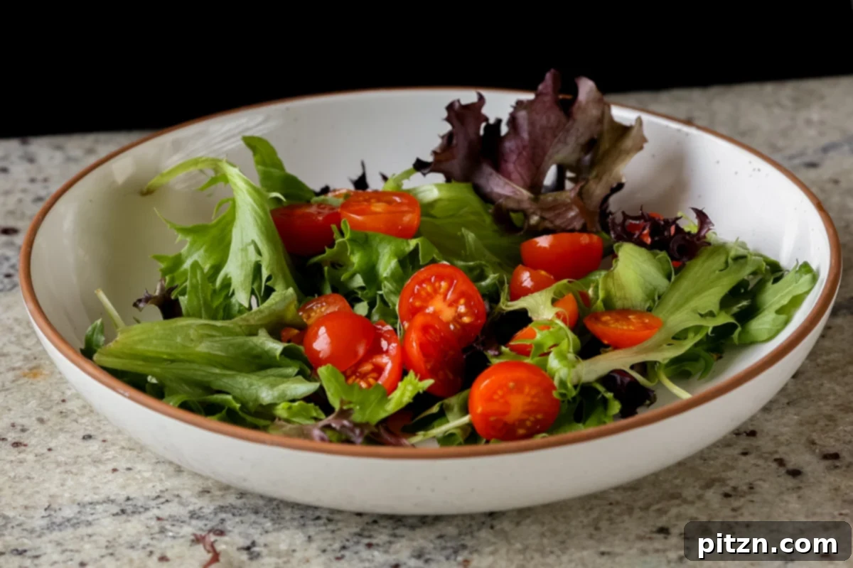 Roasted Shaved Brussels Salad with Walnut Crumble 14 lettuce and tomato in a bowl