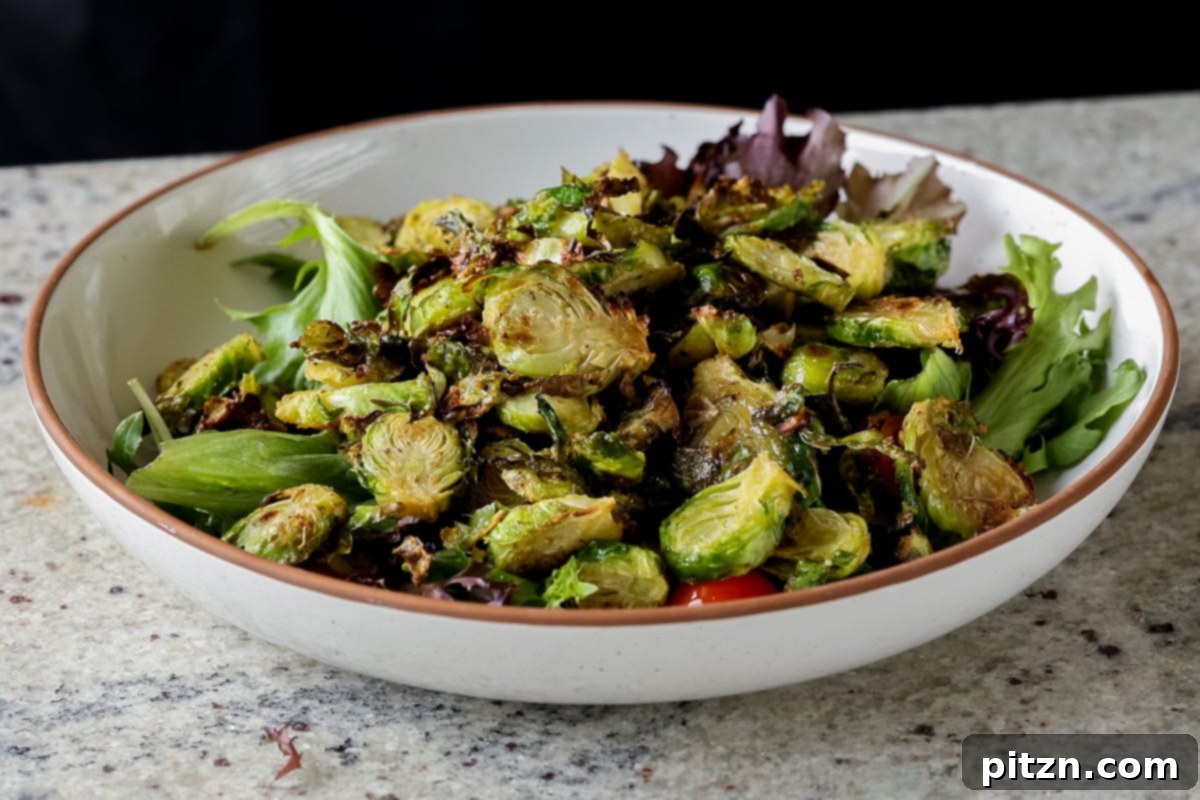Roasted Shaved Brussels Salad with Walnut Crumble 15 shaved Brussels sprouts salad in a bowl with tomatoes, lettuce before adding the walnut crumble