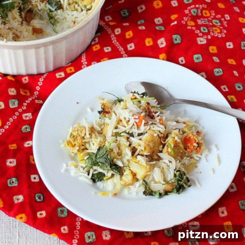 Effortless Vegan Biryani 2 A vibrant, flavorful layered vegan biryani dish with colorful vegetables and aromatic rice, presented beautifully