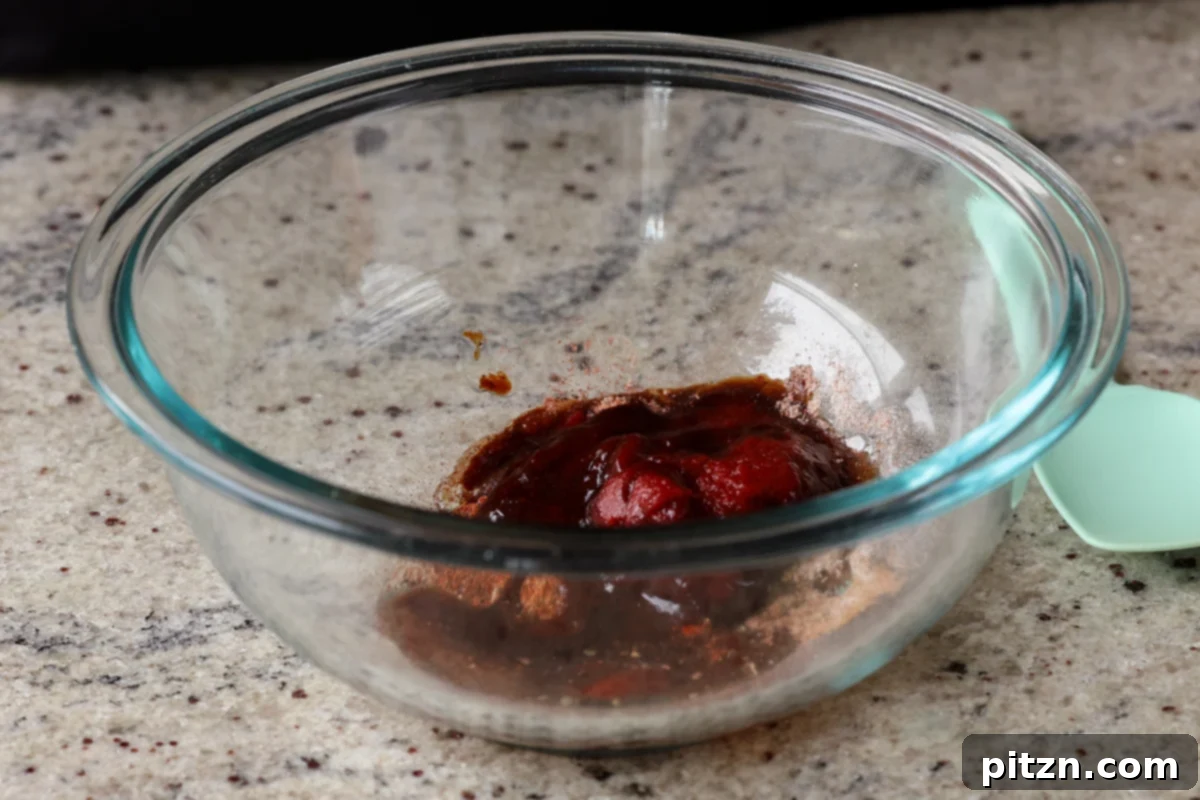Preparing the seasoning paste for the chorizo tofu in a bowl, showing the vibrant spices and tomato paste mixing together.