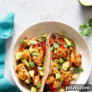 Sheet Pan Fajitas, showing fajita veggies with chipotle fajita sauce ready to be served in tacos or bowls.