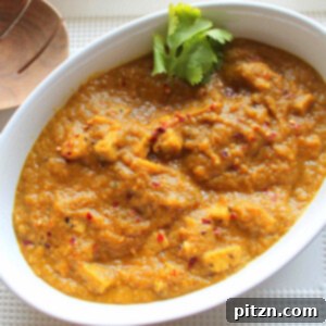 Restaurant Quality Mango Tempeh Curry Vegan Gluten Free 2 Close-up of Mango Curry Tempeh in a white bowl, garnished with fresh cilantro, ready to be served.