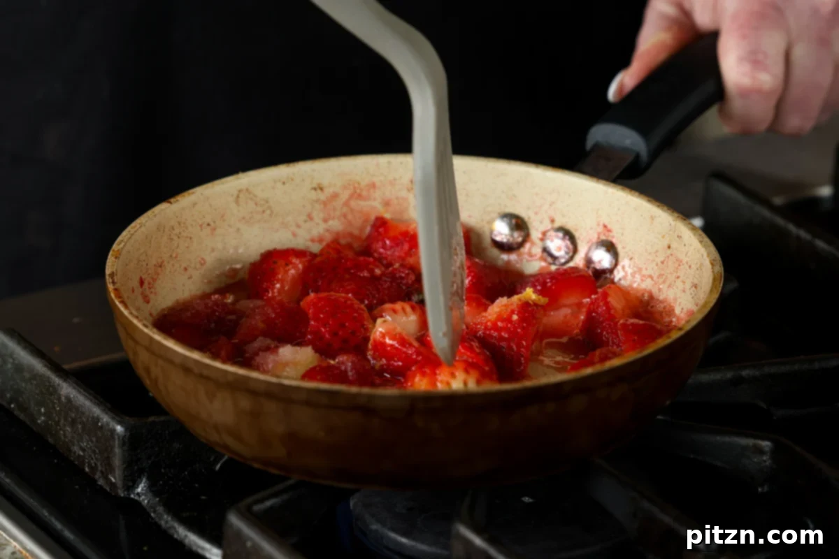 Vegan Strawberry Mousse Cake Gluten Free 16 Mashing berries with a spatula as they cook down into a compote