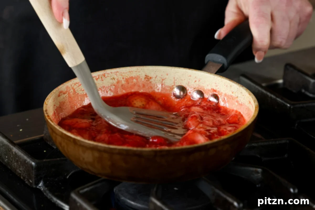 Vegan Strawberry Mousse Cake Gluten Free 17 Strawberry compote simmering and thickening in a pan on the stove