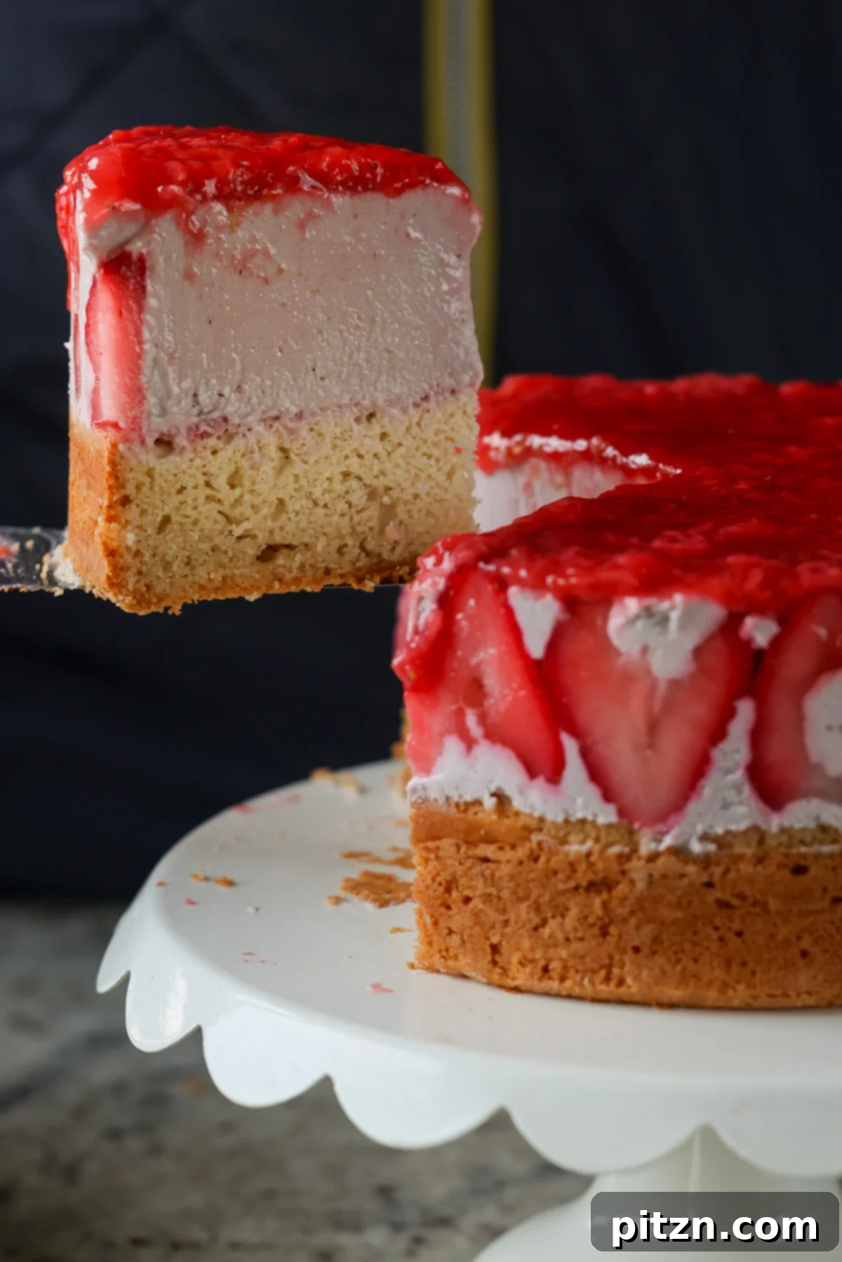 Vegan Strawberry Mousse Cake Gluten Free 3 A person cutting a perfect slice of strawberry mousse cake, revealing its beautiful layers