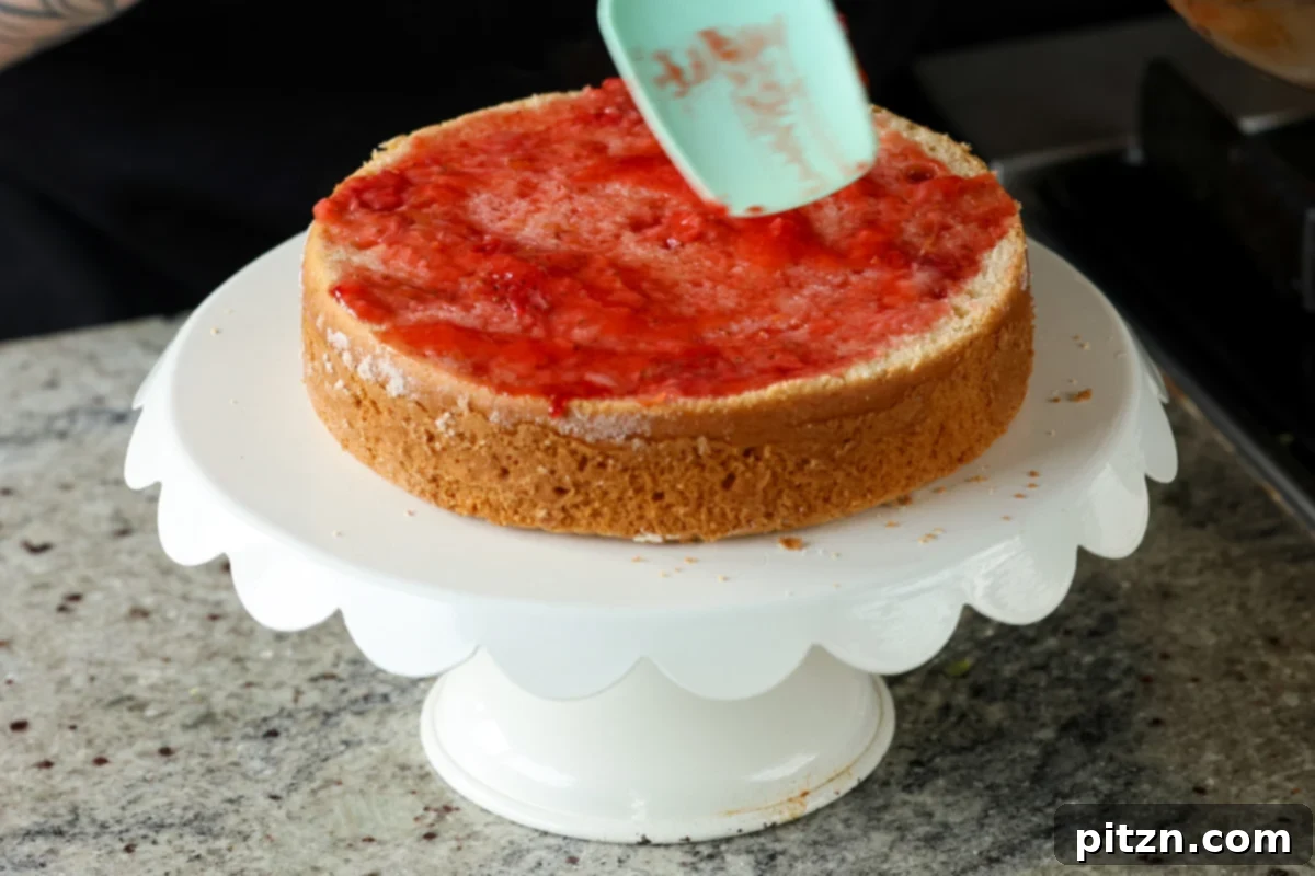 Vegan Strawberry Mousse Cake Gluten Free 22 Spreading thinned strawberry compote onto the leveled cake base