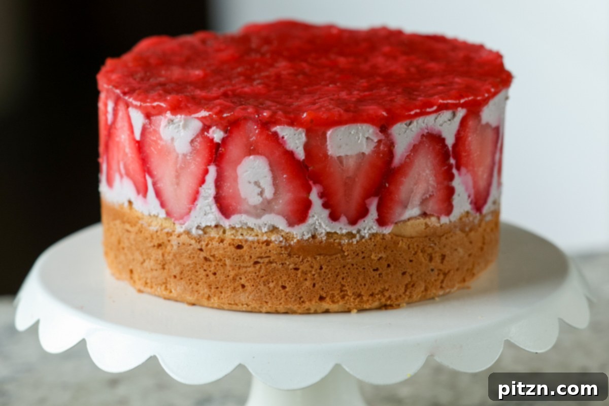 Vegan Strawberry Mousse Cake Gluten Free 28 A stunning strawberry mousse cake resting on a wooden cutting board, ready to be sliced